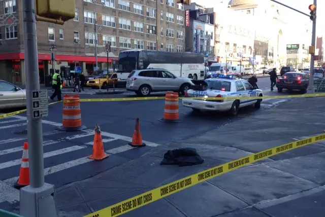 Police investigate the scene where a pedestrian was struck on the Bowery last year.